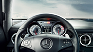 Black steering wheel and interior dashboard of a Mercedes-Benz C-Class.